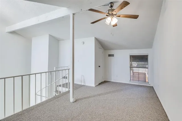 a view of an empty room with a ceiling fan