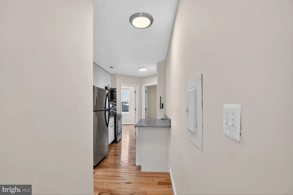 a view of a kitchen from the hallway