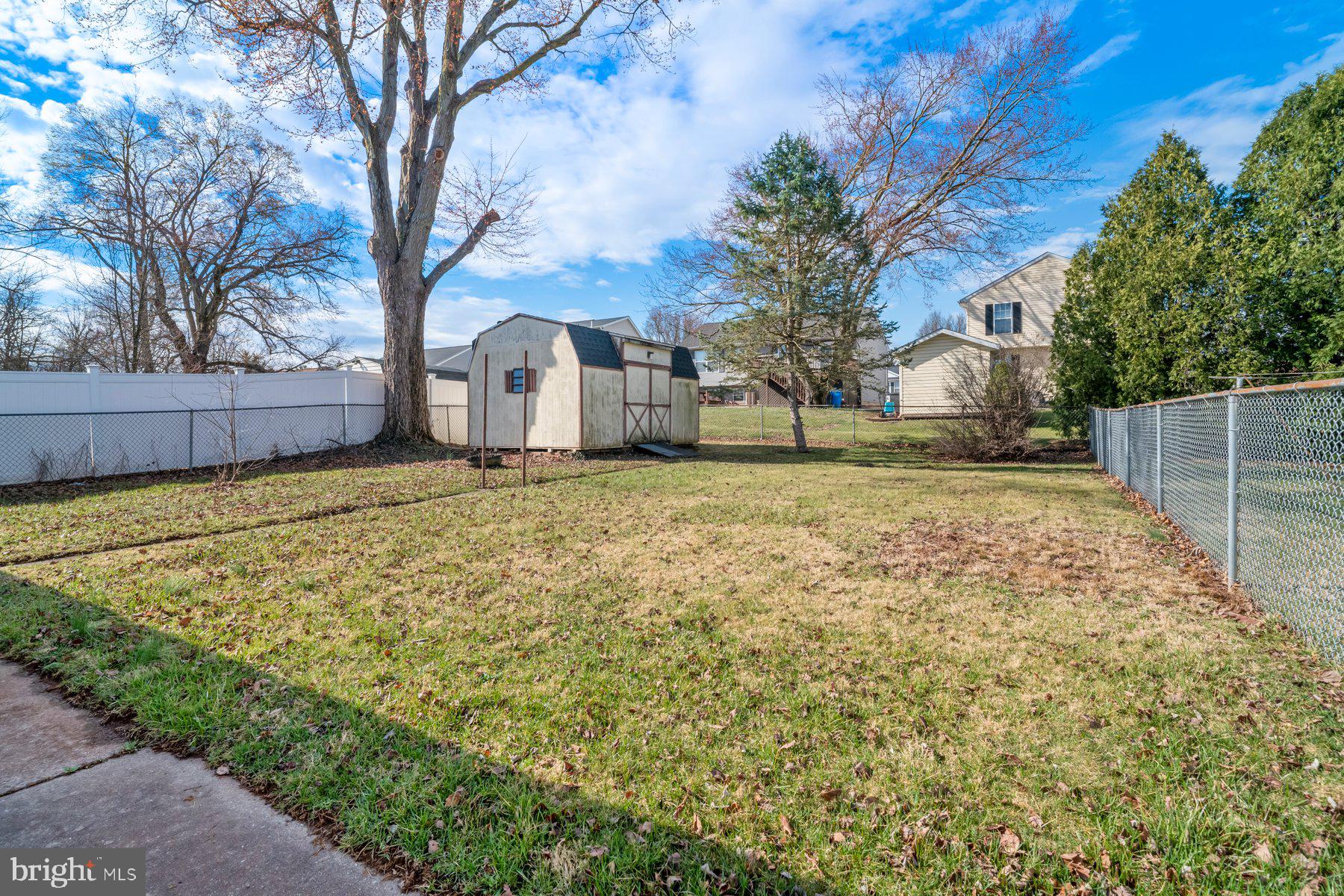23 Commerce Street Taneytown, MD 21787 - Photo 13 of 18 a brick house with a large tree in front of it