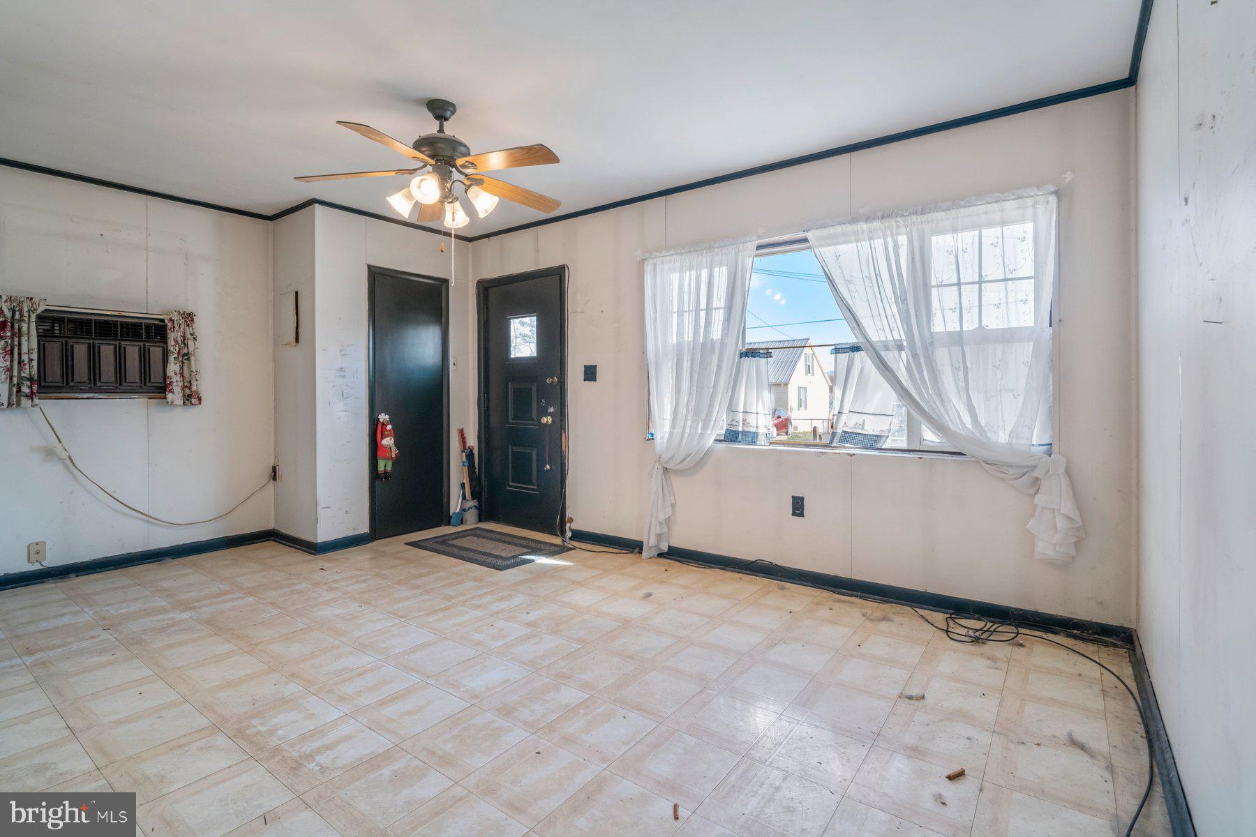 23 Commerce Street Taneytown, MD 21787 - Photo 8 of 18 an empty room with chandelier fan and windows