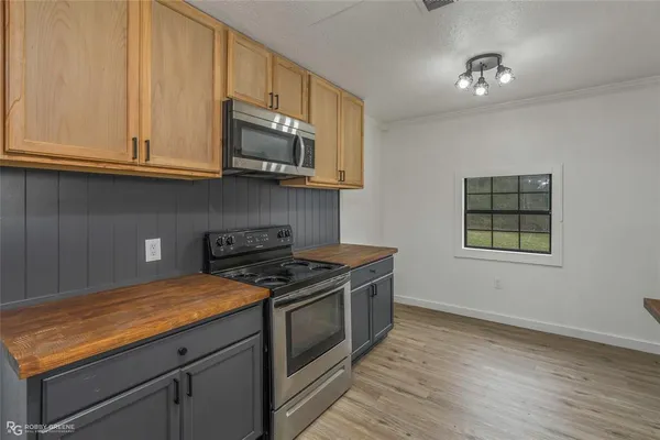 a kitchen with granite countertop a sink and cabinets