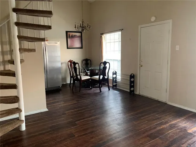 a view of a livingroom with furniture and hardwood floor