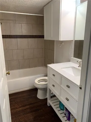 a bathroom with a sink a toilet and bathtub
