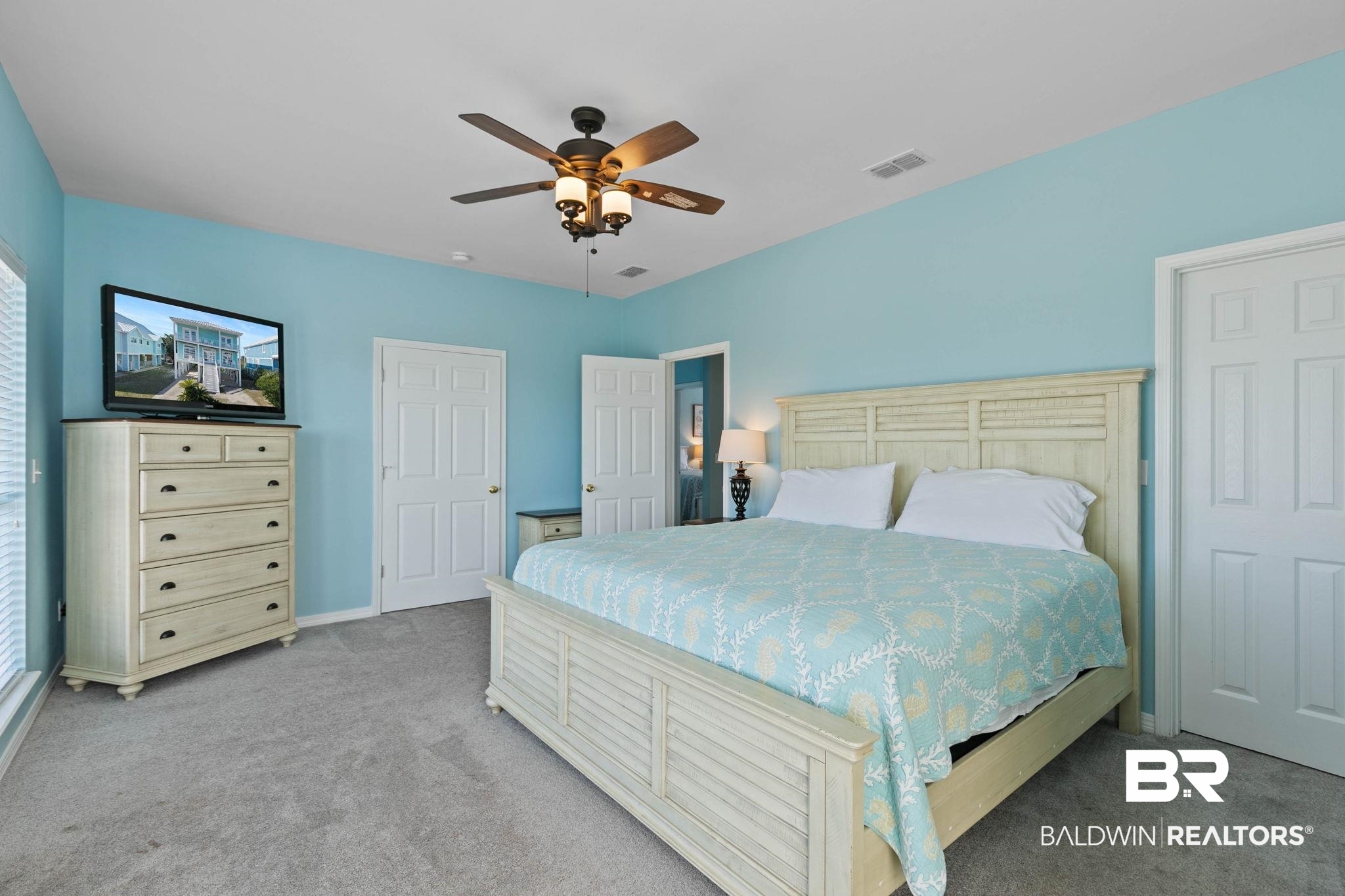 545 Plantation Road, Unit 3 Gulf Shores, AL 36542 - Photo 24 of 54 Bedroom with light colored carpet and a ceiling fan