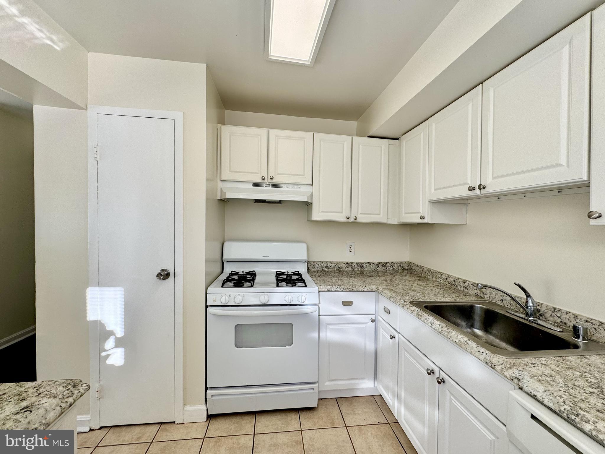 3936 Bel Pre Road, Unit 39362 Silver Spring, MD 20906 - Photo 11 of 32 a kitchen with granite countertop white cabinets and white appliances