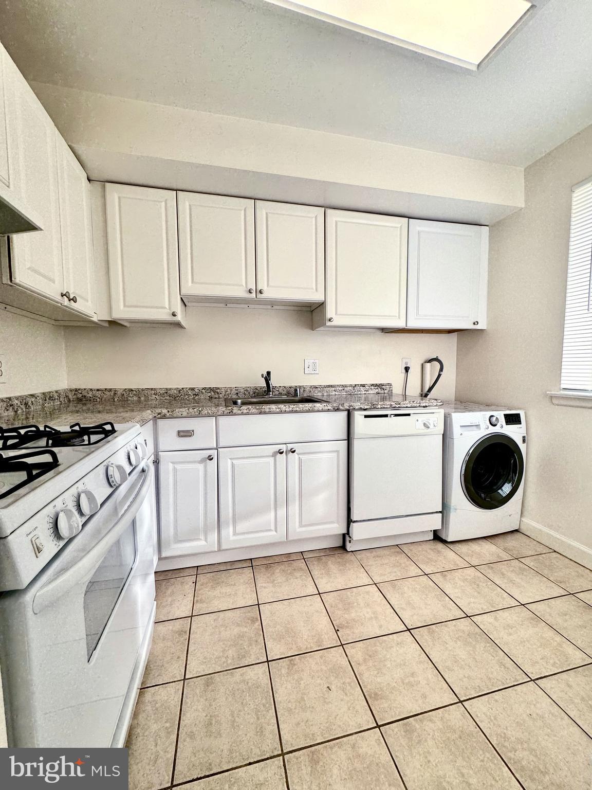 3936 Bel Pre Road, Unit 39362 Silver Spring, MD 20906 - Photo 12 of 32 a kitchen with a stove top oven sink and cabinets