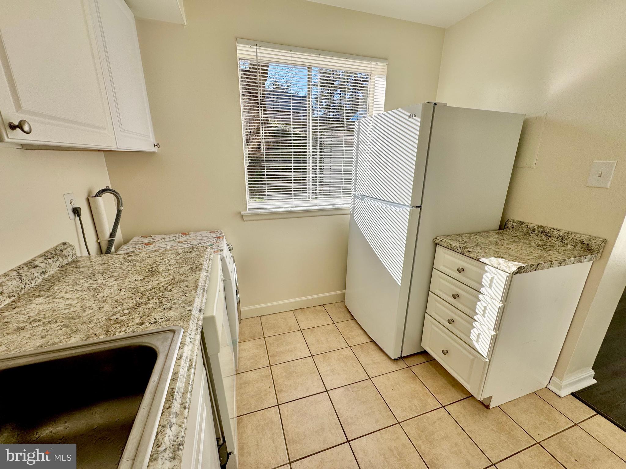 3936 Bel Pre Road, Unit 39362 Silver Spring, MD 20906 - Photo 13 of 32 a kitchen with a stove a refrigerator and a sink
