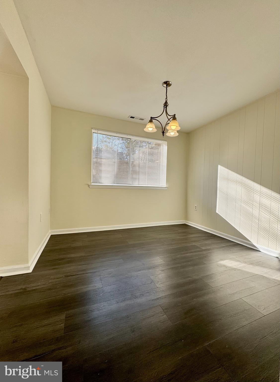 3936 Bel Pre Road, Unit 39362 Silver Spring, MD 20906 - Photo 15 of 32 a view of an empty room with wooden floor and a window