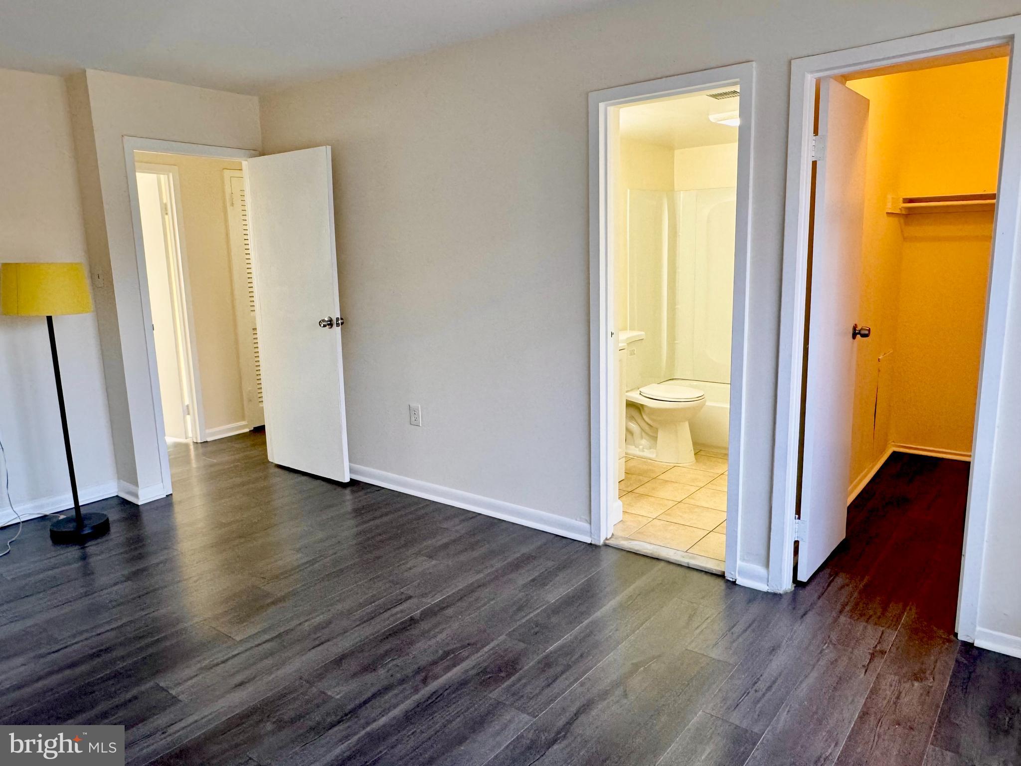 3936 Bel Pre Road, Unit 39362 Silver Spring, MD 20906 - Photo 17 of 32 a view of an empty room with wooden floor and a window