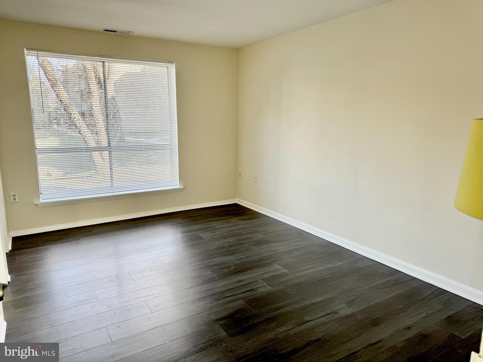 3936 Bel Pre Road, Unit 39362 Silver Spring, MD 20906 - Photo 18 of 32 an empty room with wooden floor and windows