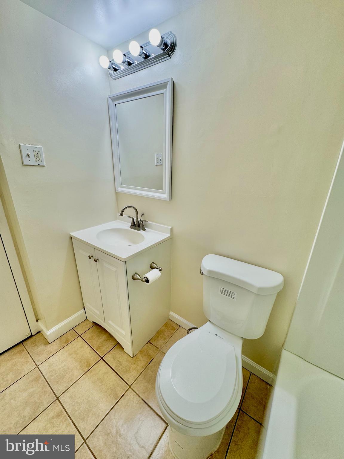 3936 Bel Pre Road, Unit 39362 Silver Spring, MD 20906 - Photo 21 of 32 a bathroom with a sink mirror vanity and toilet