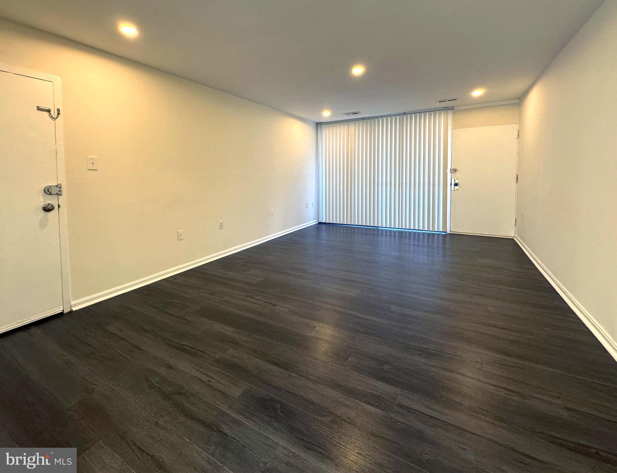 3936 Bel Pre Road, Unit 39362 Silver Spring, MD 20906 - Photo 4 of 32 an empty room with wooden floor and windows