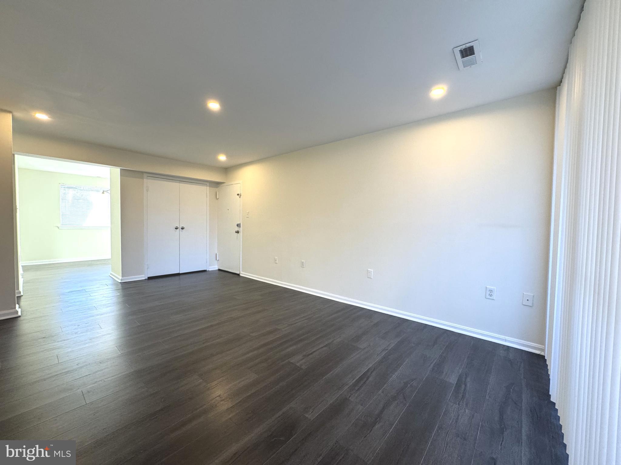 3936 Bel Pre Road, Unit 39362 Silver Spring, MD 20906 - Photo 5 of 32 an empty room with wooden floor and windows