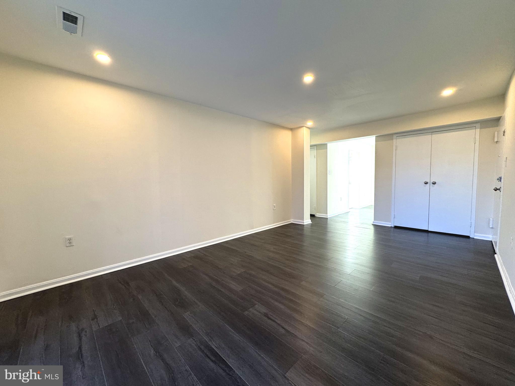 3936 Bel Pre Road, Unit 39362 Silver Spring, MD 20906 - Photo 6 of 32 an empty room with wooden floor and windows