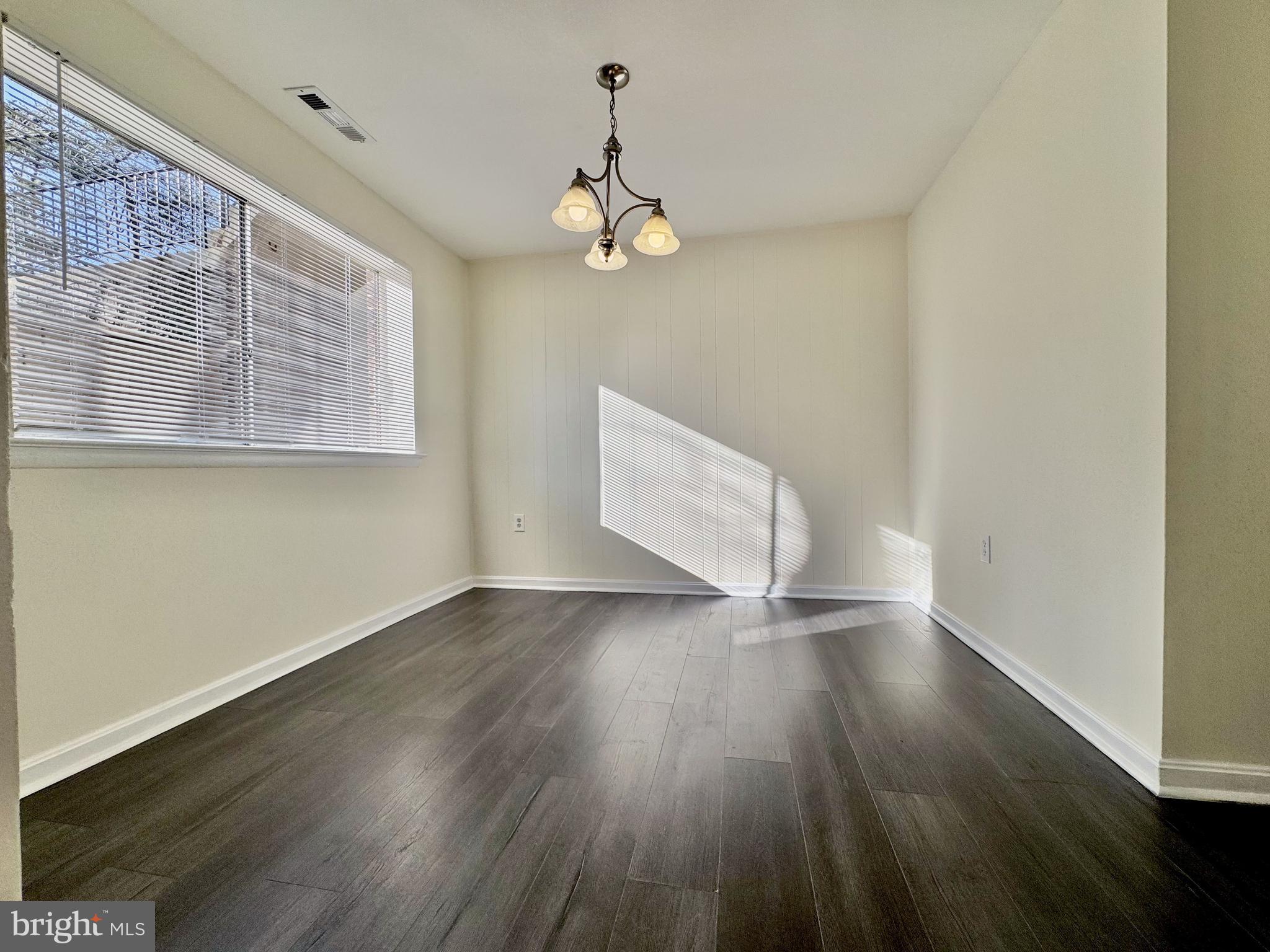 3936 Bel Pre Road, Unit 39362 Silver Spring, MD 20906 - Photo 7 of 32 a view of an empty room with wooden floor and a window