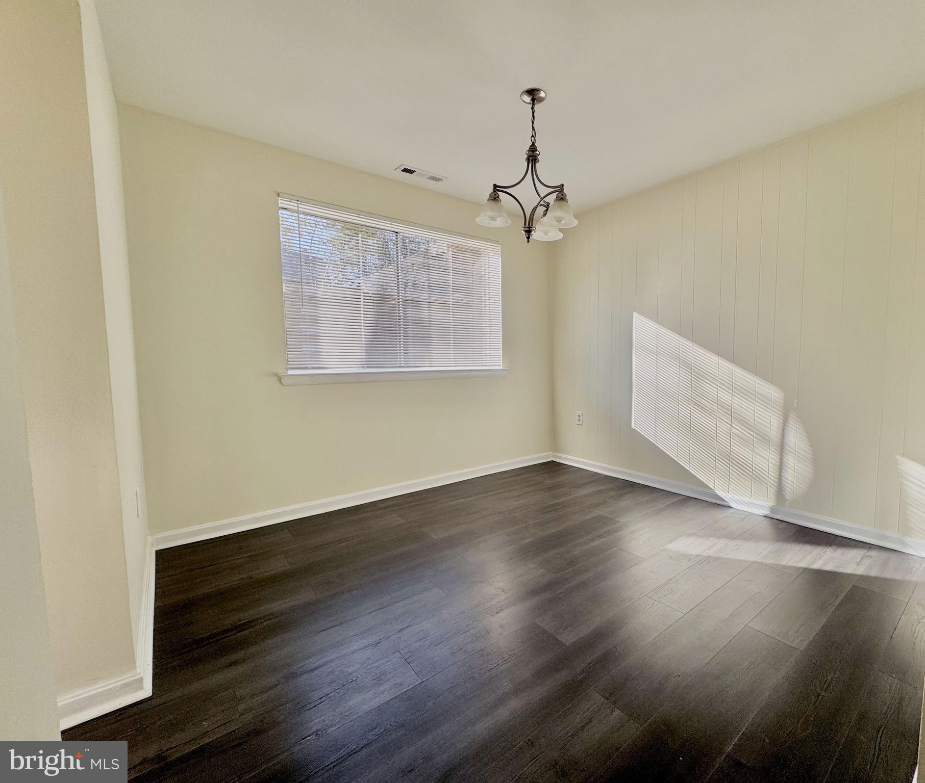 3936 Bel Pre Road, Unit 39362 Silver Spring, MD 20906 - Photo 8 of 32 an empty room with wooden floor and windows