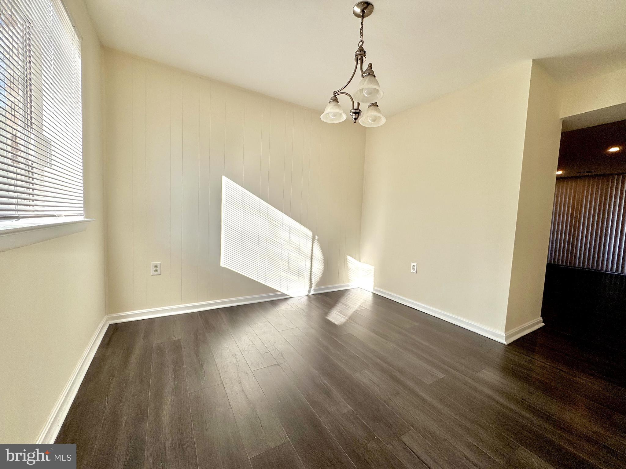 3936 Bel Pre Road, Unit 39362 Silver Spring, MD 20906 - Photo 9 of 32 wooden floor in an empty room with a window