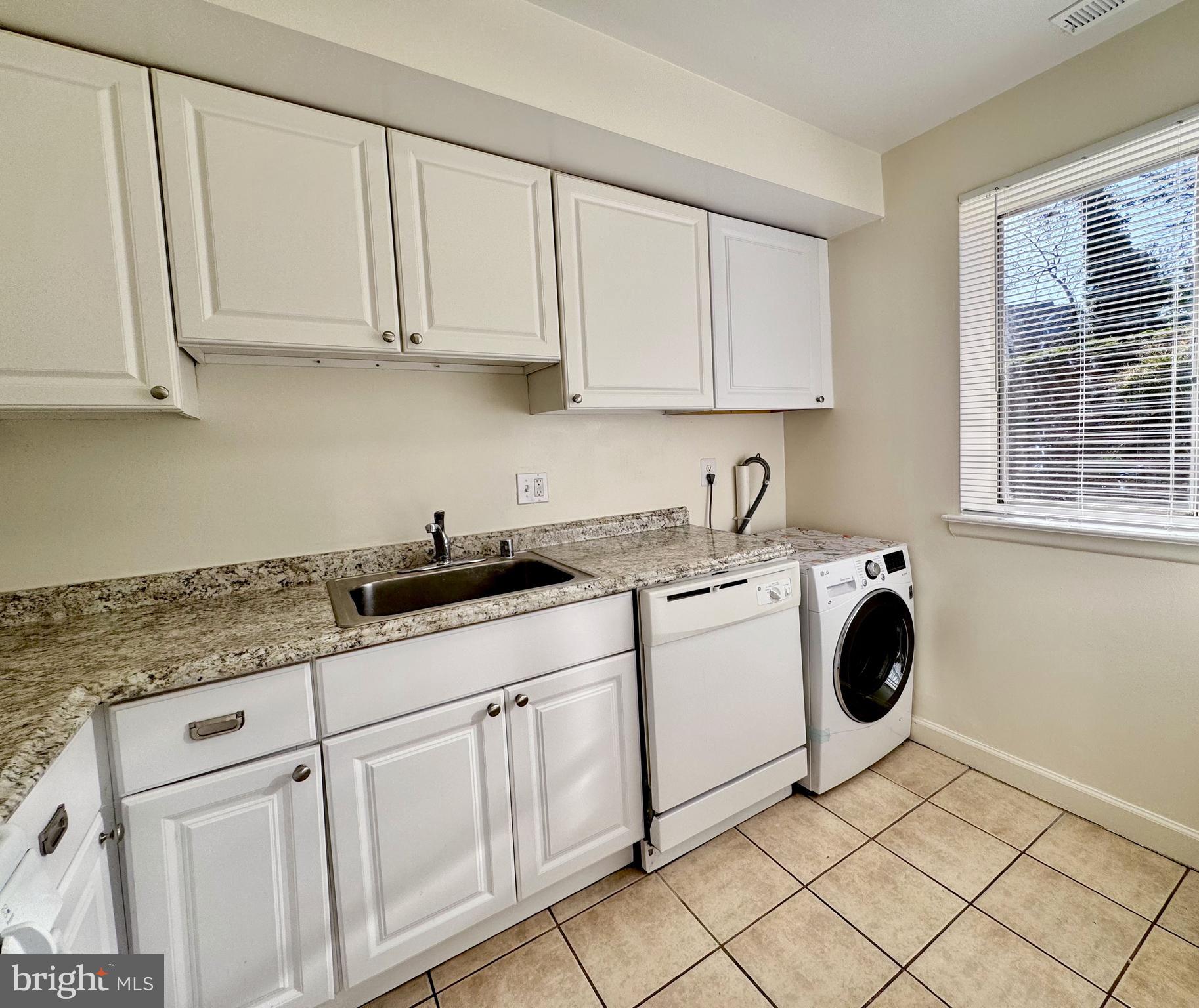 3936 Bel Pre Road, Unit 39362 Silver Spring, MD 20906 - Photo 10 of 32 a kitchen with granite countertop white cabinets and sink
