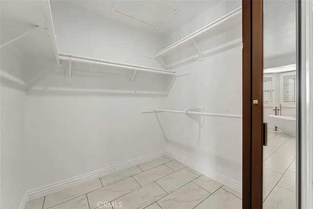 a spacious bathroom with a double vanity sink a mirror and a bathtub