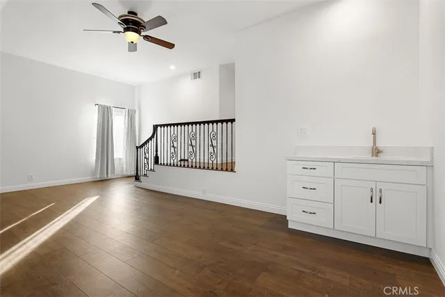 an aerial view of a city with lots of residential buildings ocean and mountain view in back