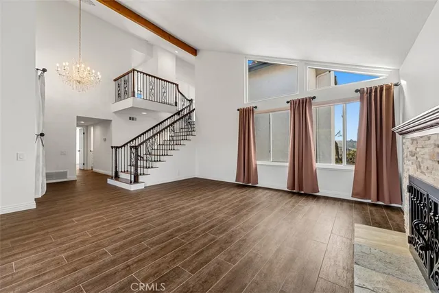 a view of an entryway with wooden floor and staircase