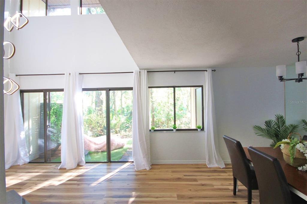 315 Southwest 54th Drive Gainesville, FL 32607 - Photo 16 of 36 a view of a dining room with furniture and wooden floor