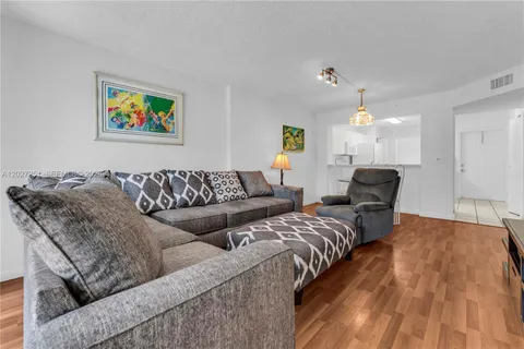 a living room with couches and painting on the wall