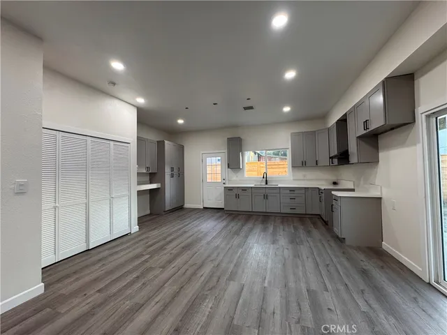 a kitchen with stainless steel appliances kitchen island wooden cabinets and granite counter tops