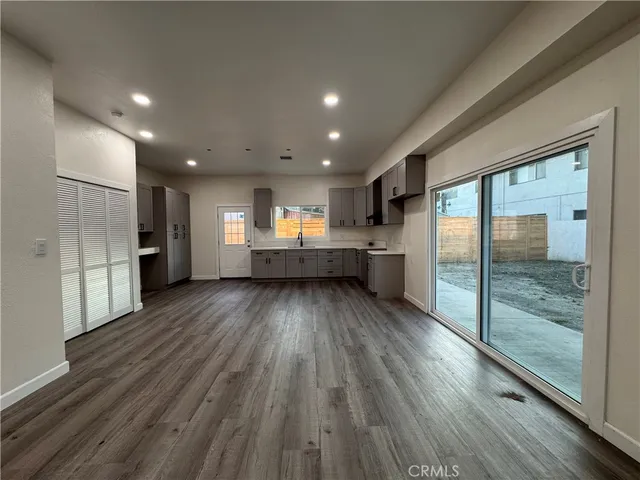 a view of kitchen with refrigerator stove and wooden floor