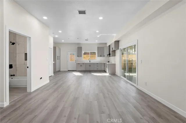 a view of kitchen with refrigerator sink and cabinets