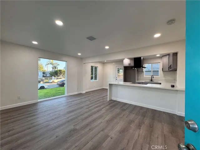 a view of kitchen with wooden floor and electronic appliances