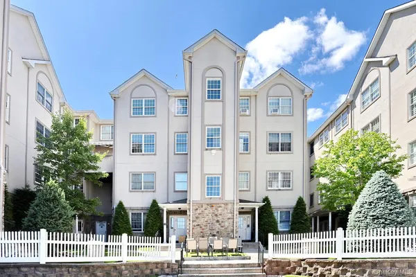 a view of a brick building next to a yard