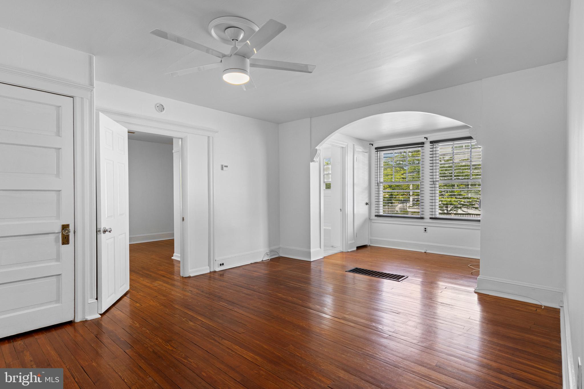 153 Conestoga Road Wayne, PA 19087 - Photo 6 of 13 an empty room with wooden floor and windows