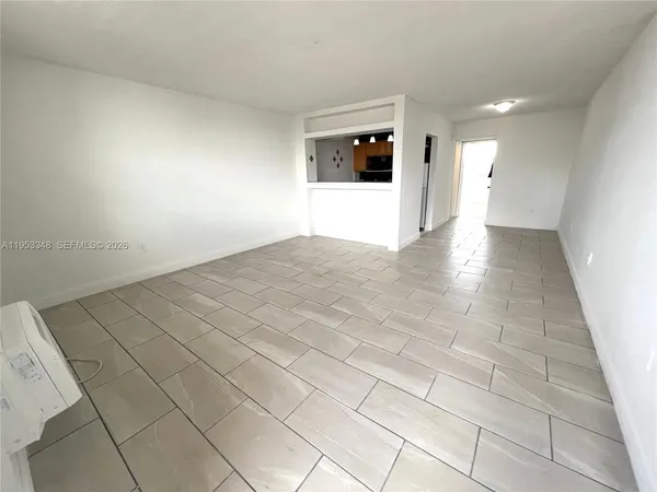 a kitchen with stainless steel appliances granite countertop a refrigerator a oven a sink dishwasher and white cabinets with wooden floor