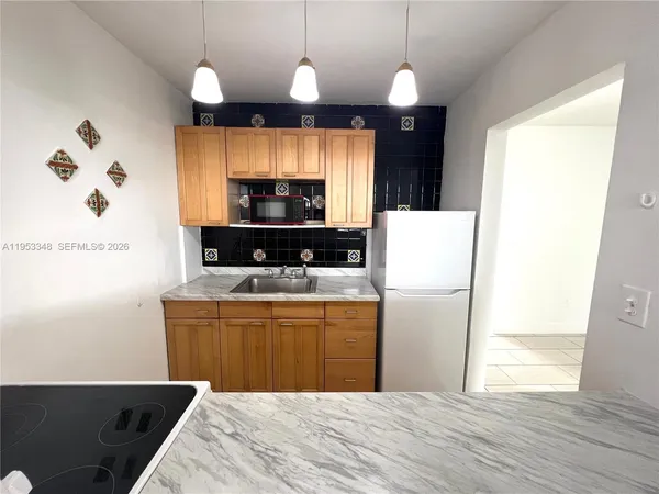 a kitchen with a sink and a stove