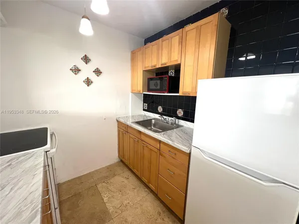 a view of a livingroom with wooden floor and natural light