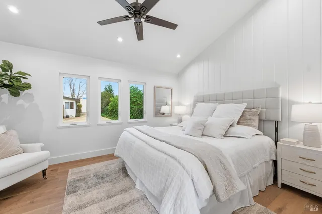 a balcony with wooden floor table and chairs