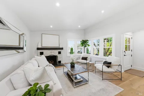 a living room with furniture fireplace and window