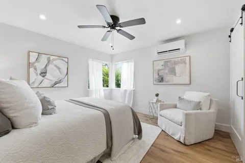 a bedroom with furniture and a wooden floor