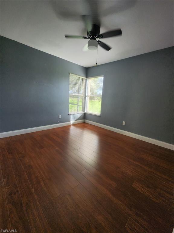 12796 Vista Pine Circle Fort Myers, FL 33913 - Photo 18 of 25 an empty room with wooden floor and windows
