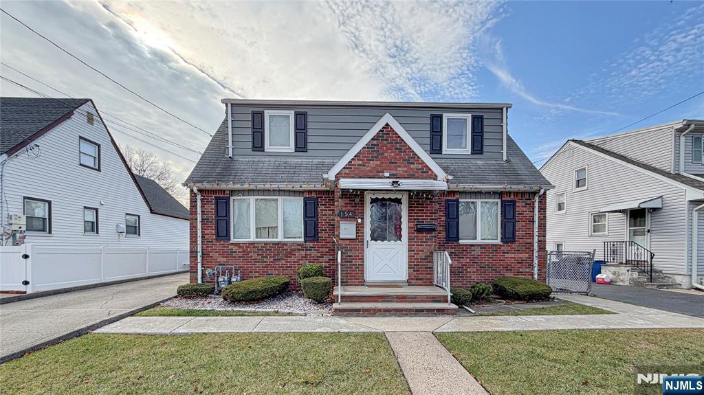 154 Charlton Avenue, Unit 2 Lodi, NJ 07644 - Photo 1 of 14 a front view of a house with garden