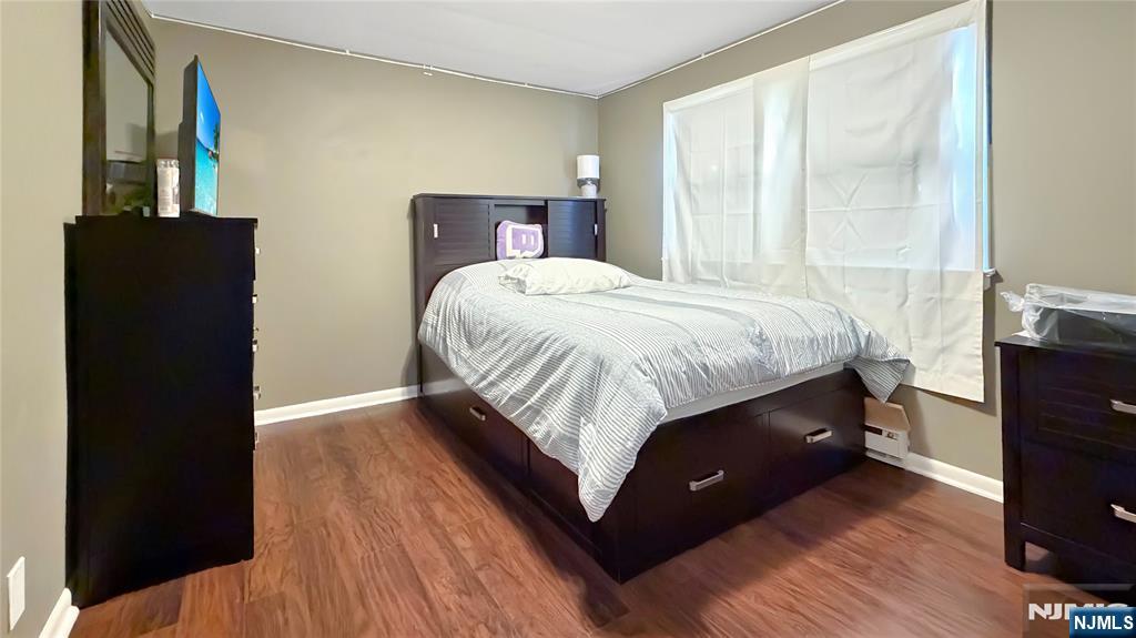 154 Charlton Avenue, Unit 2 Lodi, NJ 07644 - Photo 11 of 14 a bed sitting in a bedroom next to a window