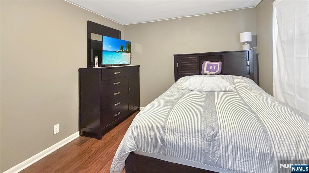 154 Charlton Avenue, Unit 2 Lodi, NJ 07644 - Photo 12 of 14 a bedroom with a bed and a flat screen tv