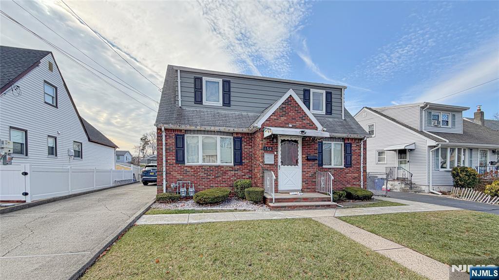 154 Charlton Avenue, Unit 2 Lodi, NJ 07644 - Photo 13 of 14 a front view of a house with a yard