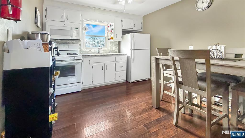 154 Charlton Avenue, Unit 2 Lodi, NJ 07644 - Photo 6 of 14 a kitchen with cabinets and wooden floor