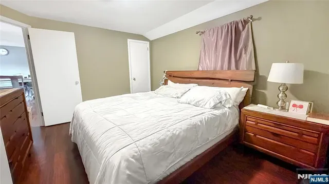 a bed sitting in a bedroom next to a lamp