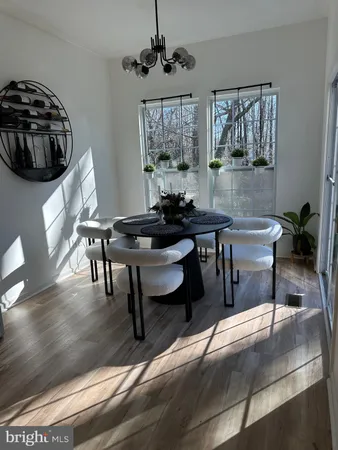 a living room with furniture a window and a chandelier