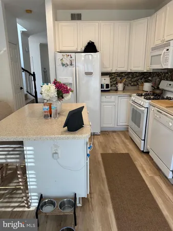 a kitchen with a sink appliances and cabinets