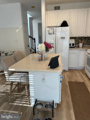 a kitchen with a table and chairs