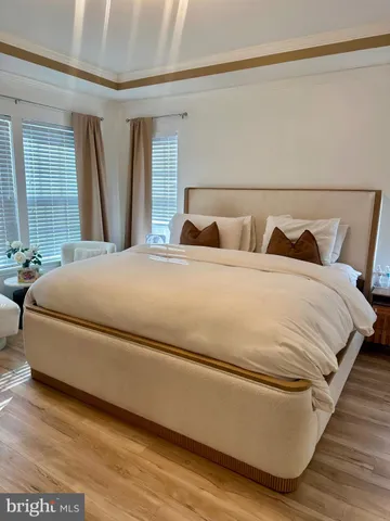 a large bed sitting in a bedroom next to a window